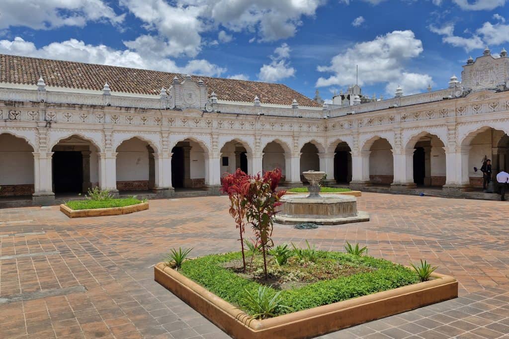 The white facade and entrance of the Museo de Arte Colonial in Antigua Guatemala.