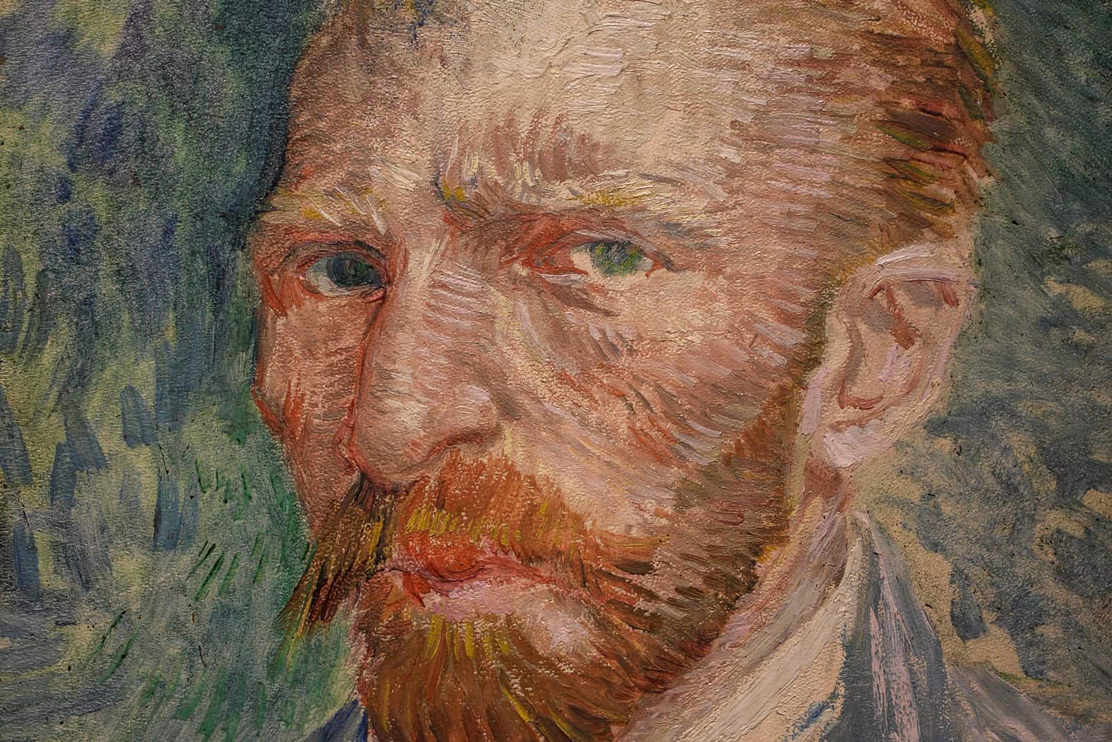 Vincent van Gogh faces the viewer against a blue-green background in his 1887 self-portrait.