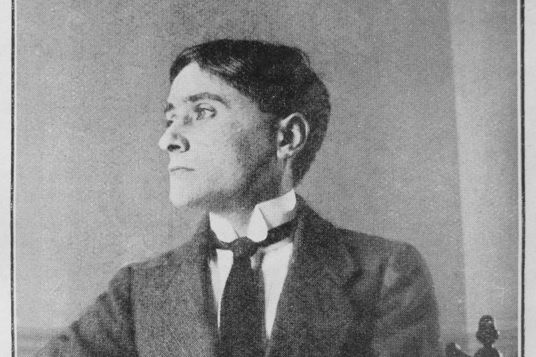 A black-and-white 1913 portrait shows Cubist painter Jean Metzinger in a dark suit.