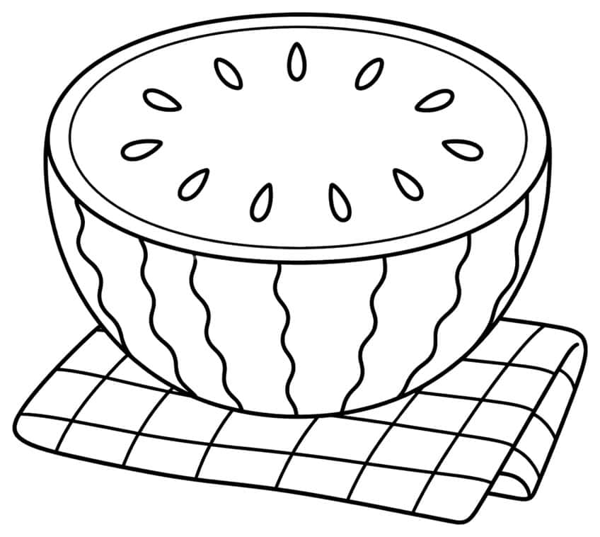 Watermelon half with seeds resting on a checkered picnic cloth