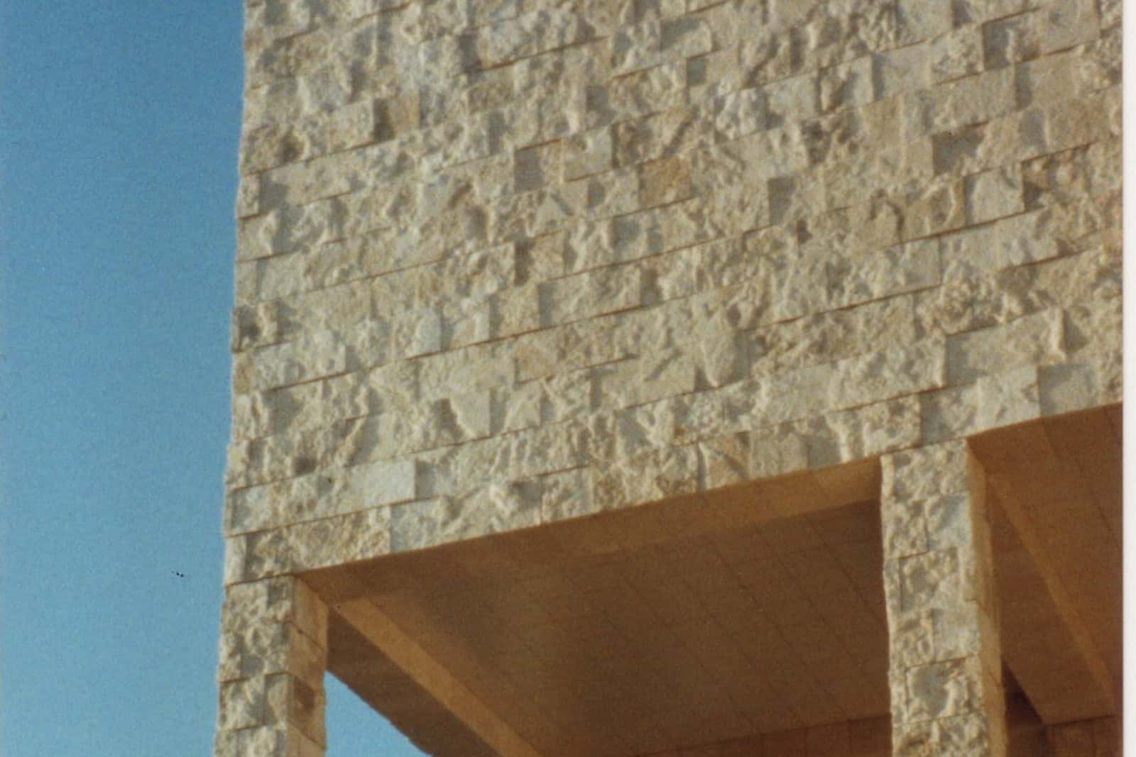 A Getty Center facade clad in pale travertine panels rises against the sky.