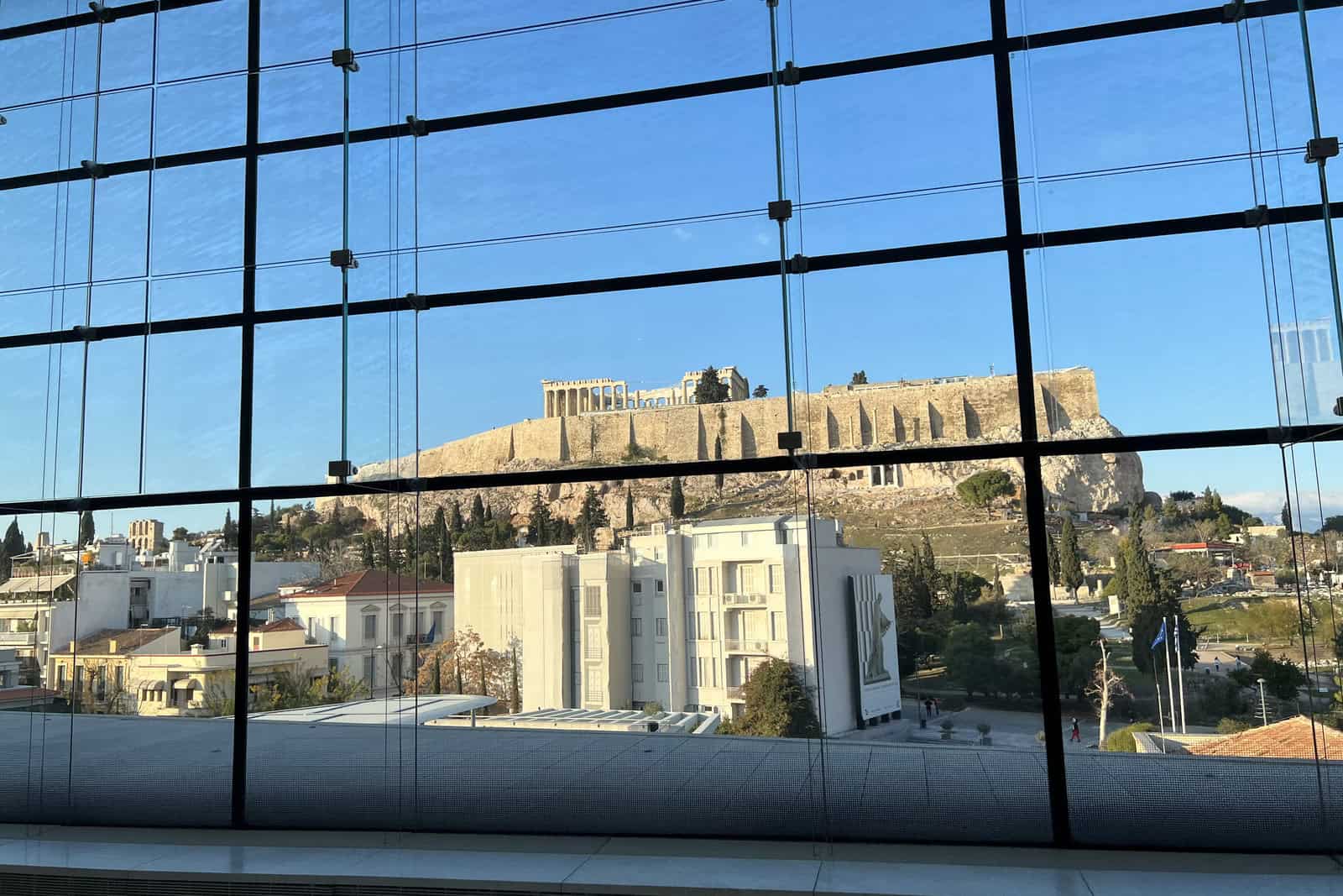 The glass-walled upper floor of the Acropolis Museum overlooks the Acropolis and the Parthenon in Athens.