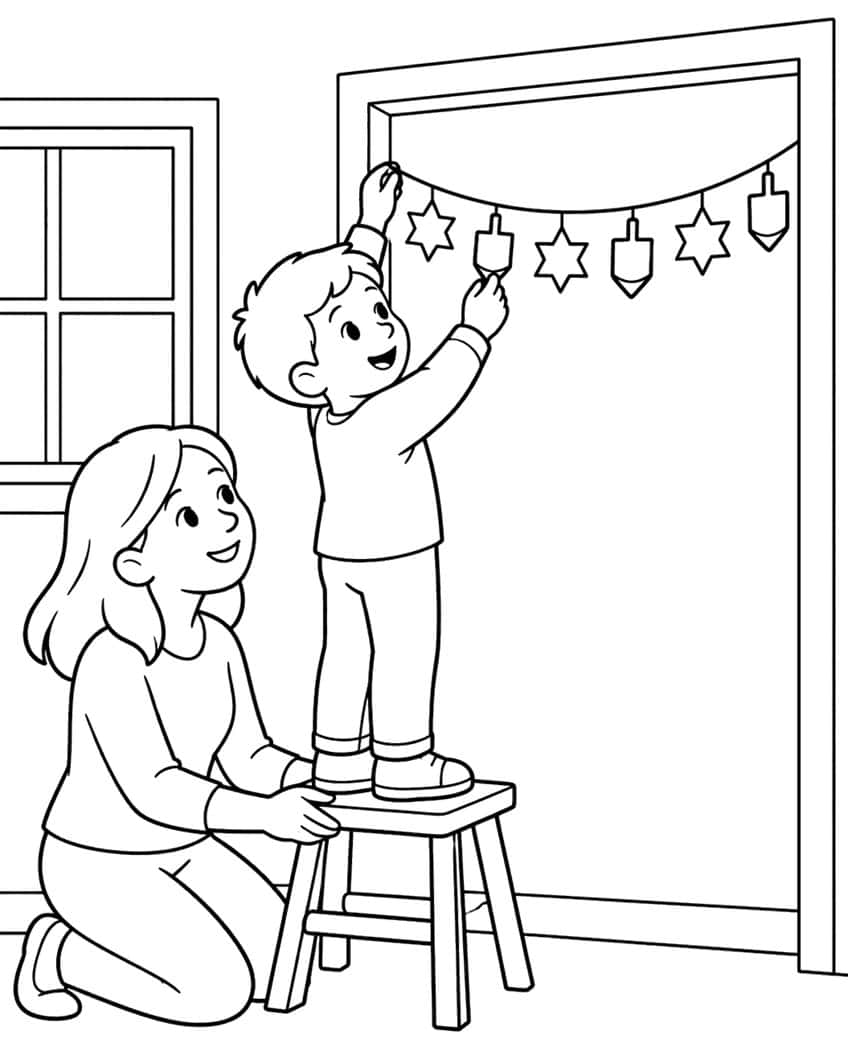 Boy on a stool hangs a garland of stars and dreidels while a kneeling woman holds the stool