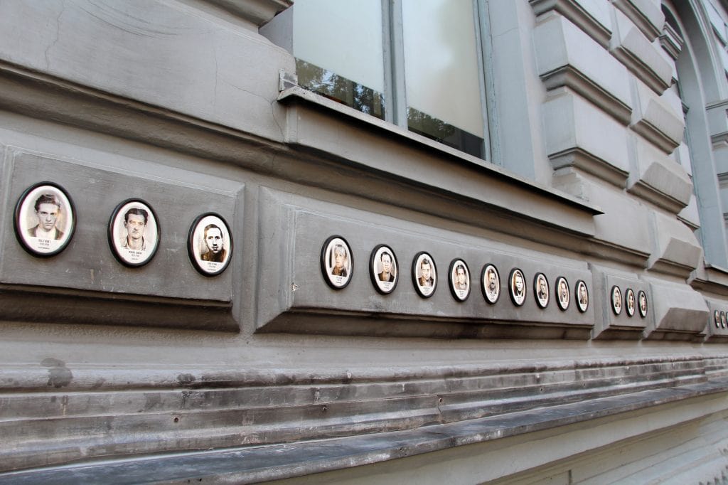 The gray House of Terror Museum in Budapest stands beneath a black canopy spelling TERROR across its facade.