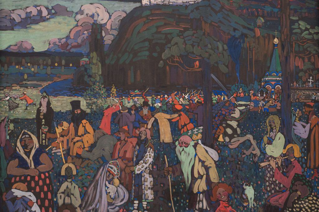 Wassily Kandinsky’s Das bunte Leben shows a dense landscape filled with brightly colored figures, a horseman, trees, water, and a distant city.