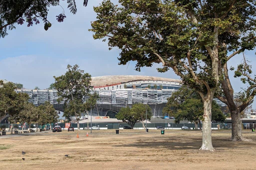 The curved white Lucas Museum of Narrative Art rises above its construction site in Los Angeles in August 2023.