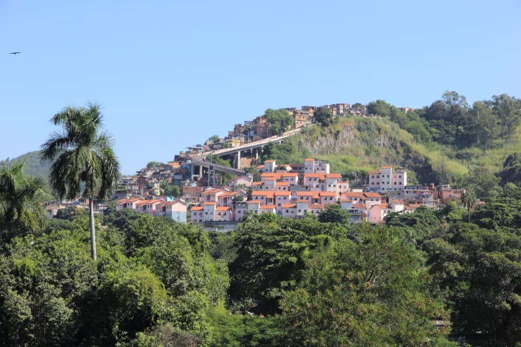 Morro da Mangueira rises beyond trees and buildings in Rio de Janeiro, seen from Quinta da Boa Vista.