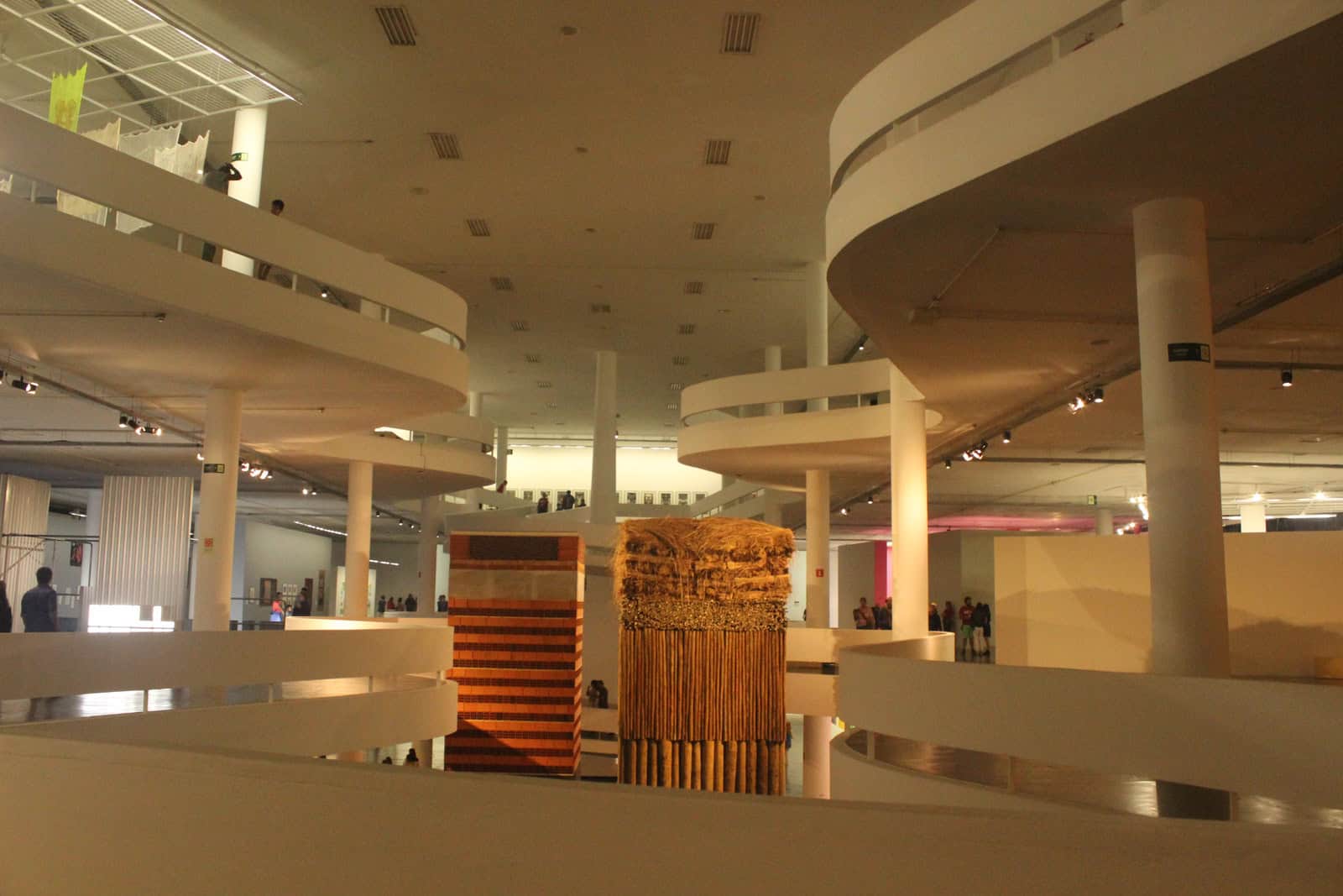 Curving ramp and open exhibition floors inside the São Paulo Bienal pavilion.