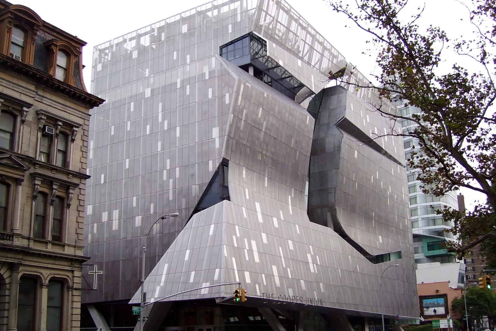 Cooper Union’s angular stainless-steel New Academic Building rises above pedestrians and traffic at 41 Cooper Square.