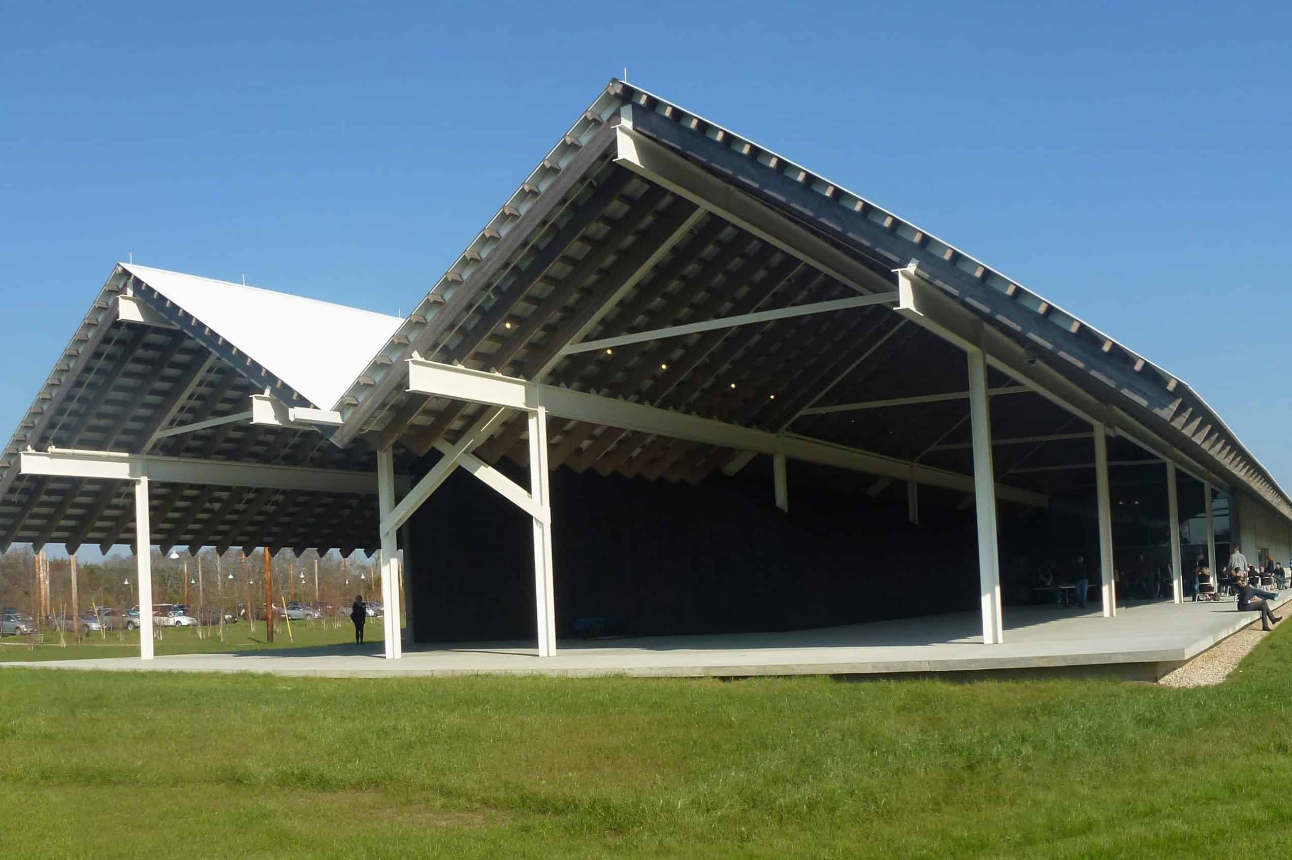The long, twin-gabled Parrish Art Museum pavilion extends across a green lawn in Water Mill, New York.
