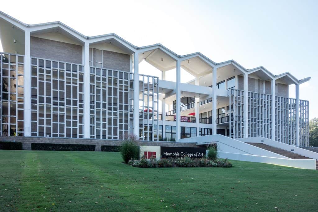 Rust Hall’s white mid-century facade and angular roofline rise above the lawn in Overton Park.