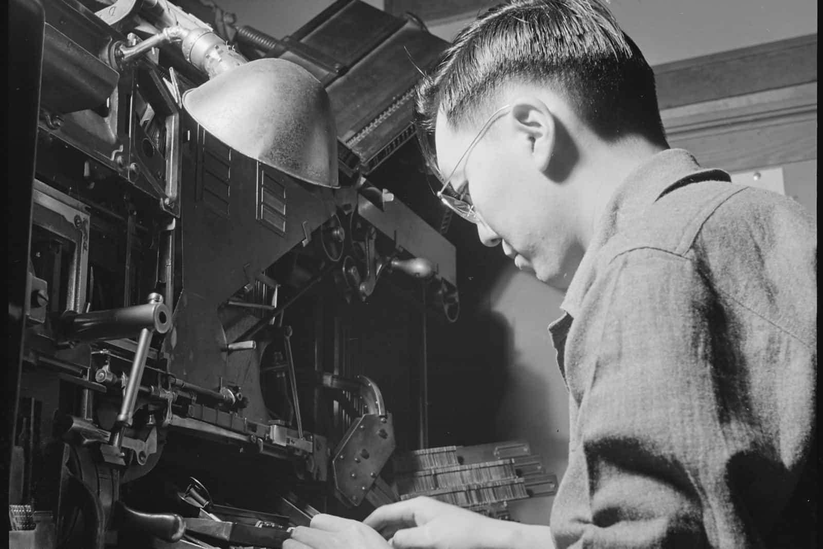 Bill Hosokawa working at a linotype machine while producing the Heart Mountain Sentinel in 1943.