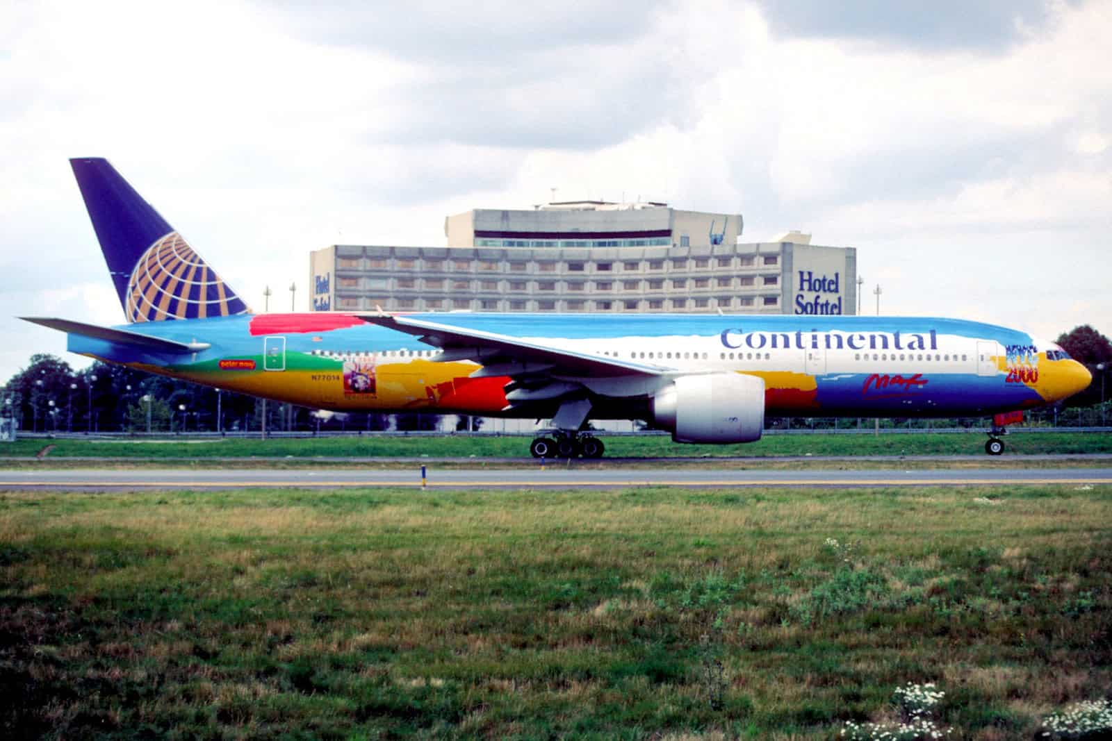 A Continental Airlines Boeing 777 in Peter Max’s multicolored NYC 2000 livery taxis at Paris Charles de Gaulle Airport.