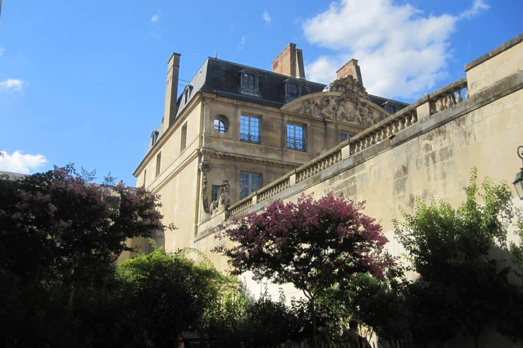A side view of the Hôtel Salé, home of the Musée National Picasso-Paris, seen across its garden.