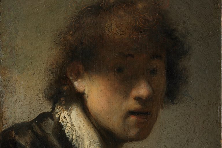 Young Rembrandt looks out from deep shadow, with light catching his cheek and tousled curls in the 1629 self-portrait.