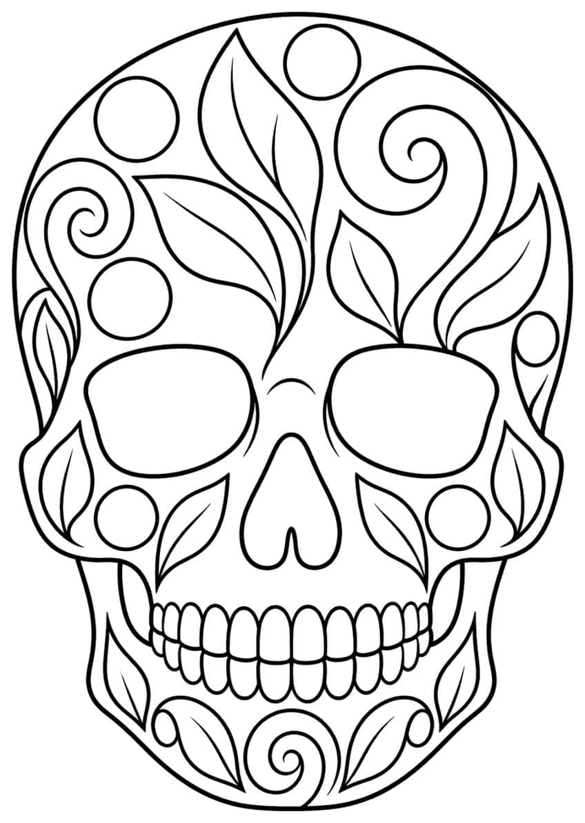 Front view of a sugar skull decorated with leaves, spirals and circles, with large eye sockets and teeth