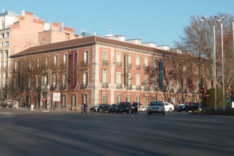 The pale stone façade of the Museo Nacional Thyssen-Bornemisza’s Villahermosa Palace in Madrid beneath a blue sky.