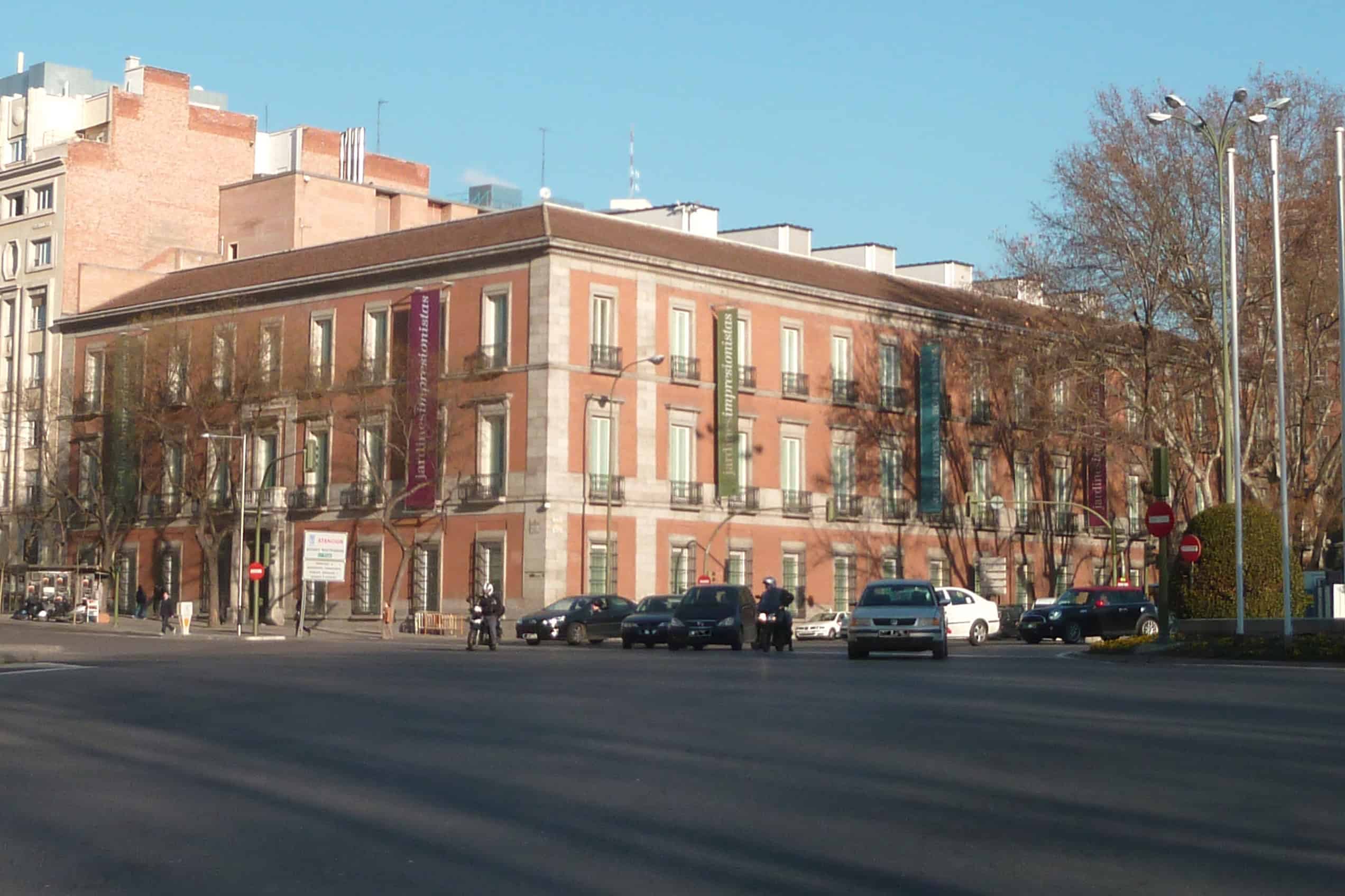 The pale stone façade of the Museo Nacional Thyssen-Bornemisza’s Villahermosa Palace in Madrid beneath a blue sky.