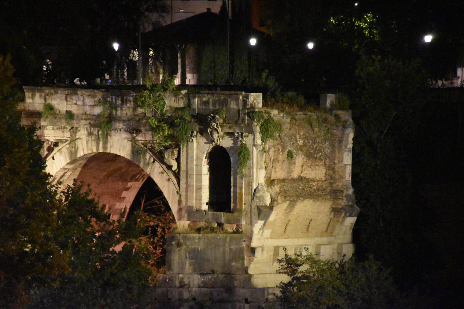 The single surviving stone arch of Ponte Rotto standing in the Tiber in Rome.