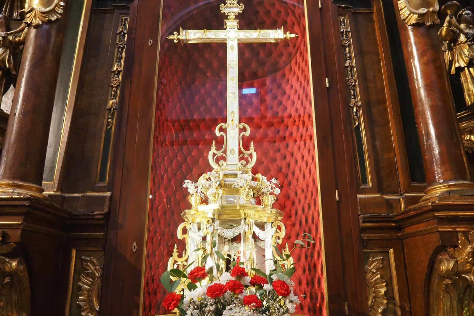 A silver cross-shaped Lignum Crucis reliquary displayed inside the Vera Cruz church in Valladolid.