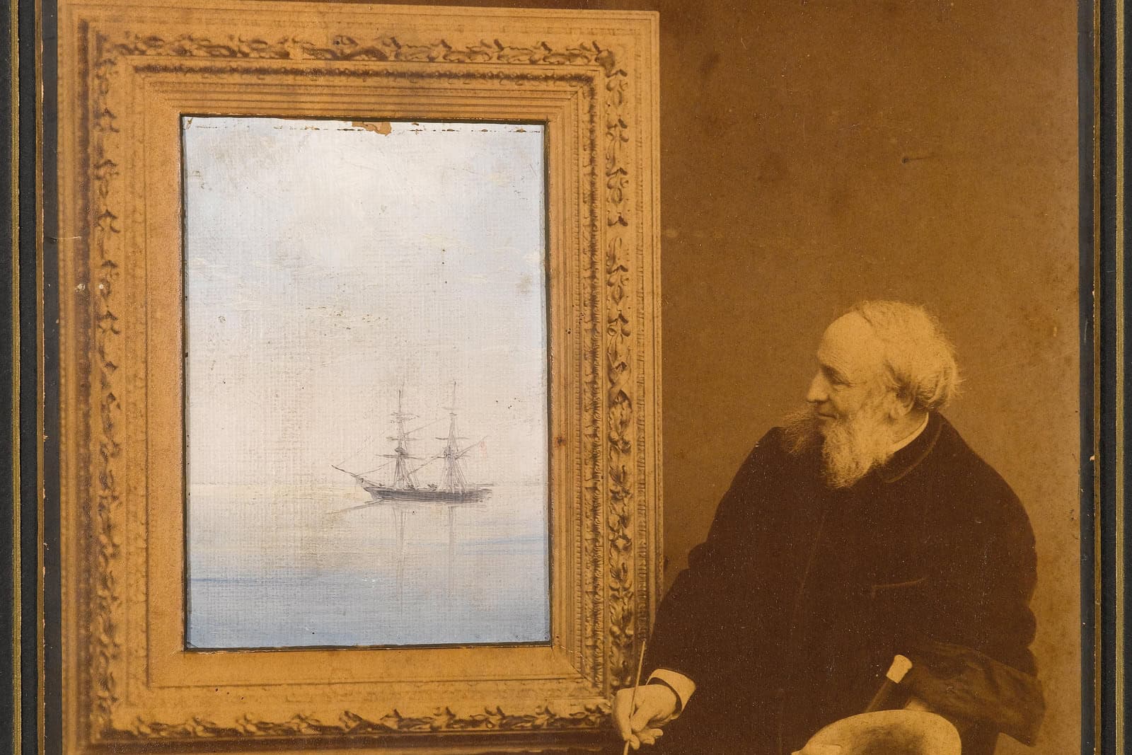 Portrait of Ivan Aivazovsky above a small painted seascape