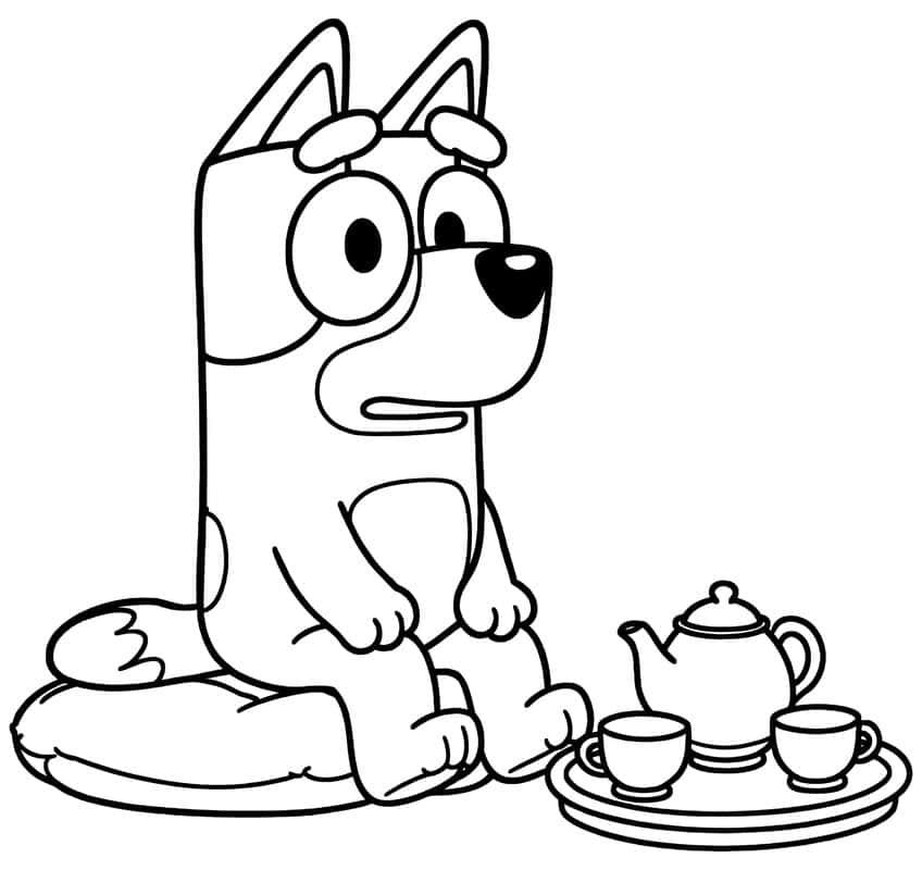 Pup sitting on a round cushion beside a tray with a teapot and two teacups