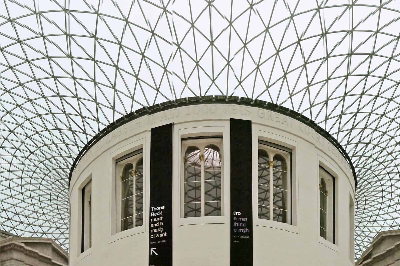 Panoramic interior view of the British Museum's Great Court beneath its curved glass roof.