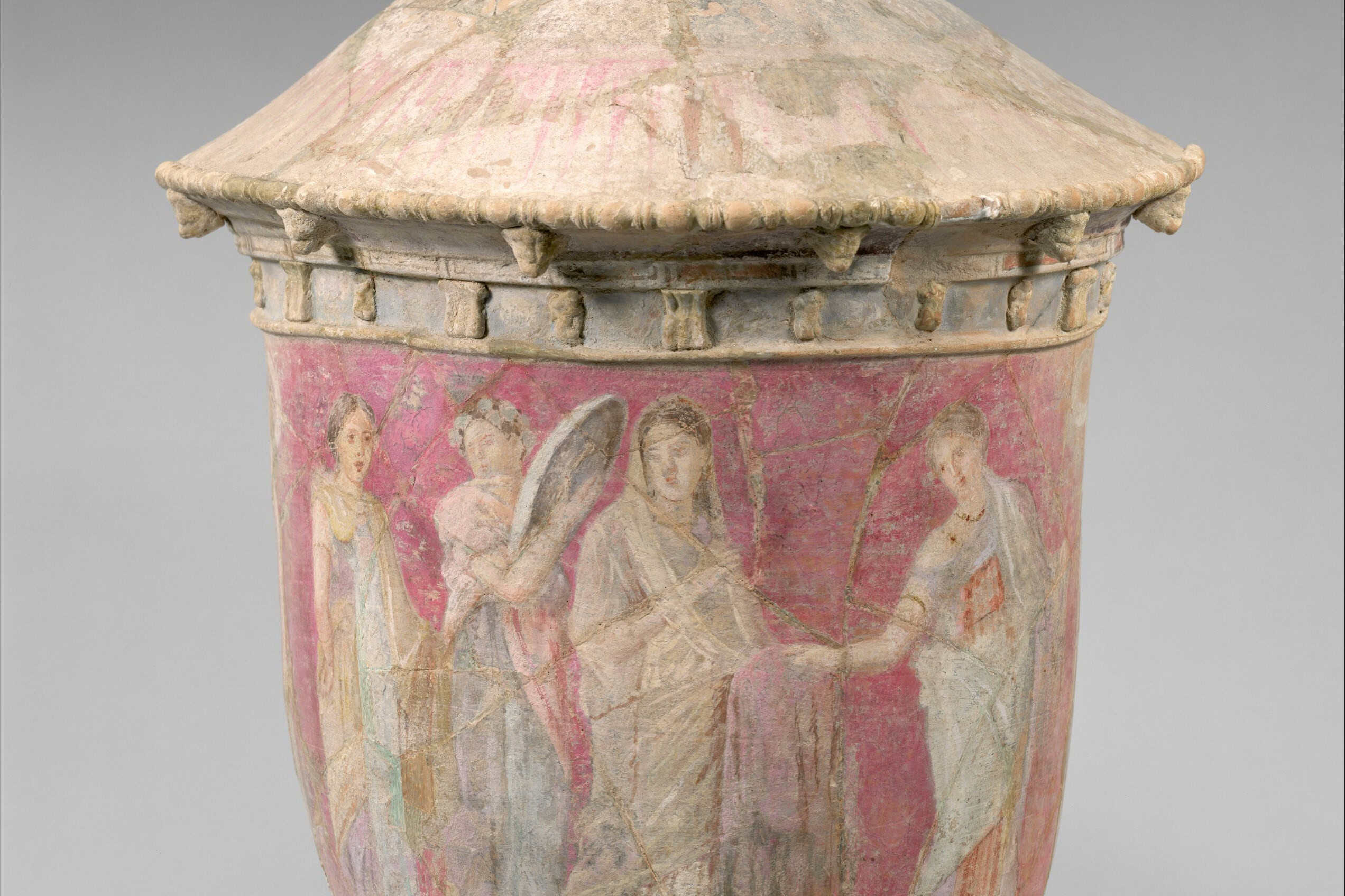 A tall terracotta Centuripe funerary vase painted with a bride and attendants.