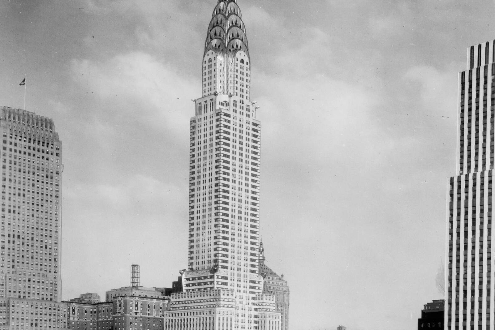 Black-and-white circa-1930 view of the Chrysler Building rising above Midtown Manhattan.