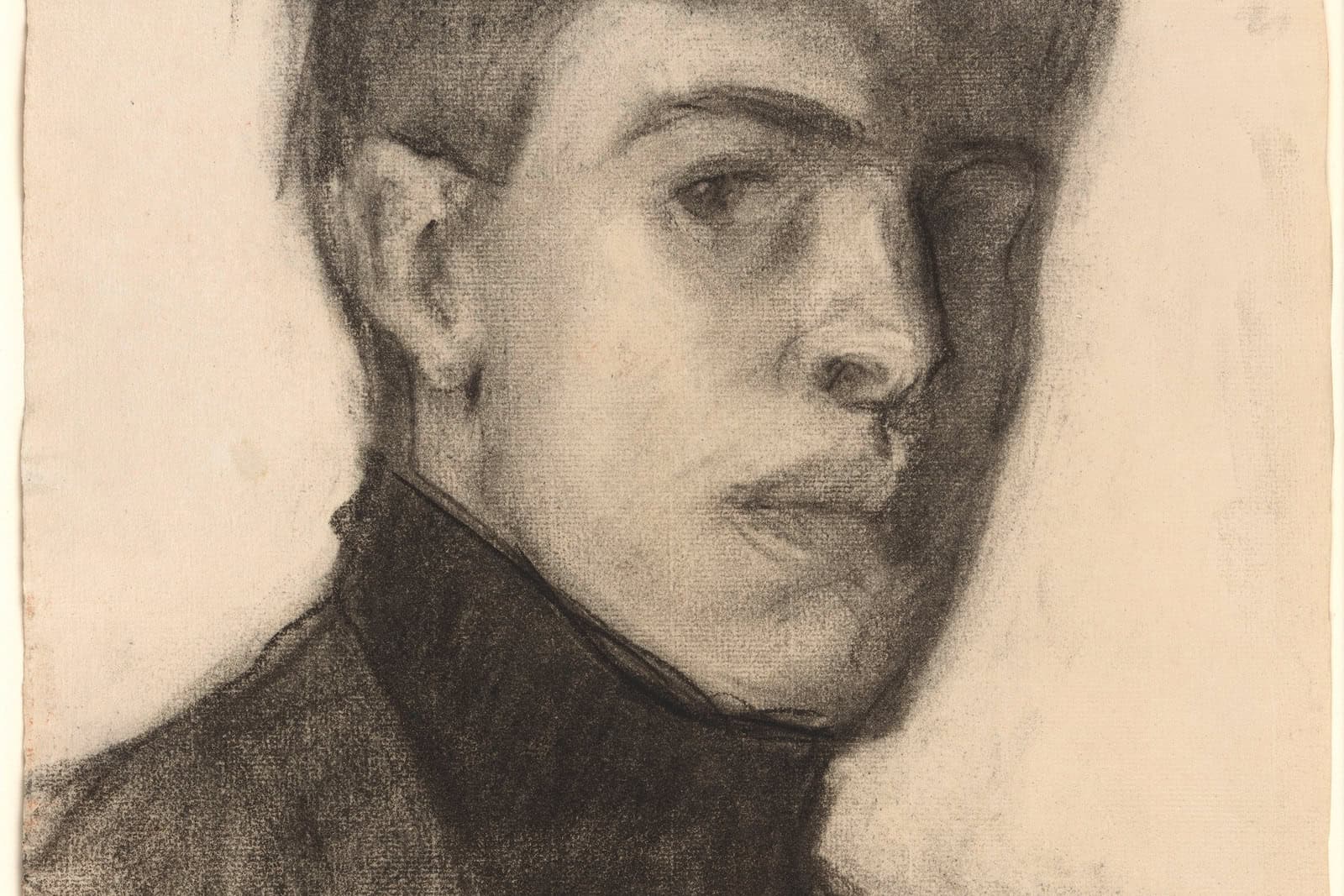 Edward Hopper looks toward the viewer in a 1903 charcoal self-portrait.