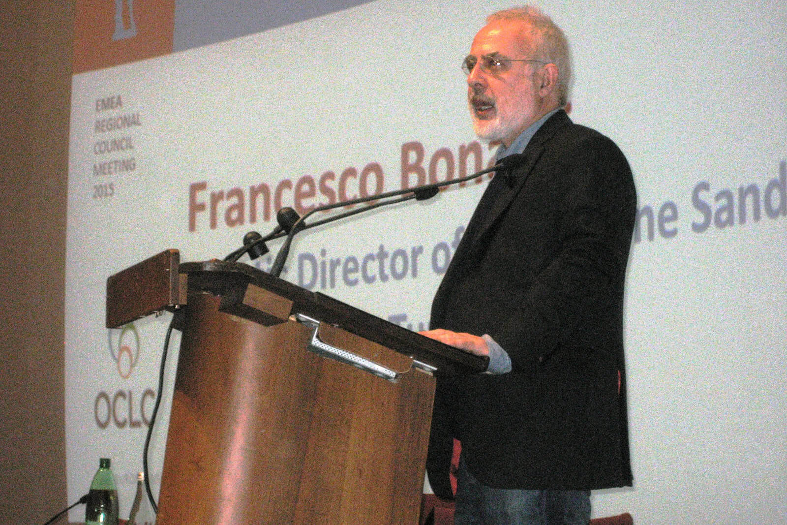Francesco Bonami speaks at a lectern during a 2015 conference in Florence.