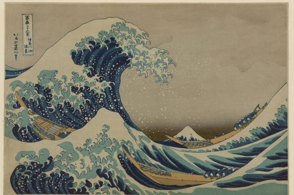 Hokusai’s Great Wave curls above three boats while snowcapped Mount Fuji appears on the distant horizon.