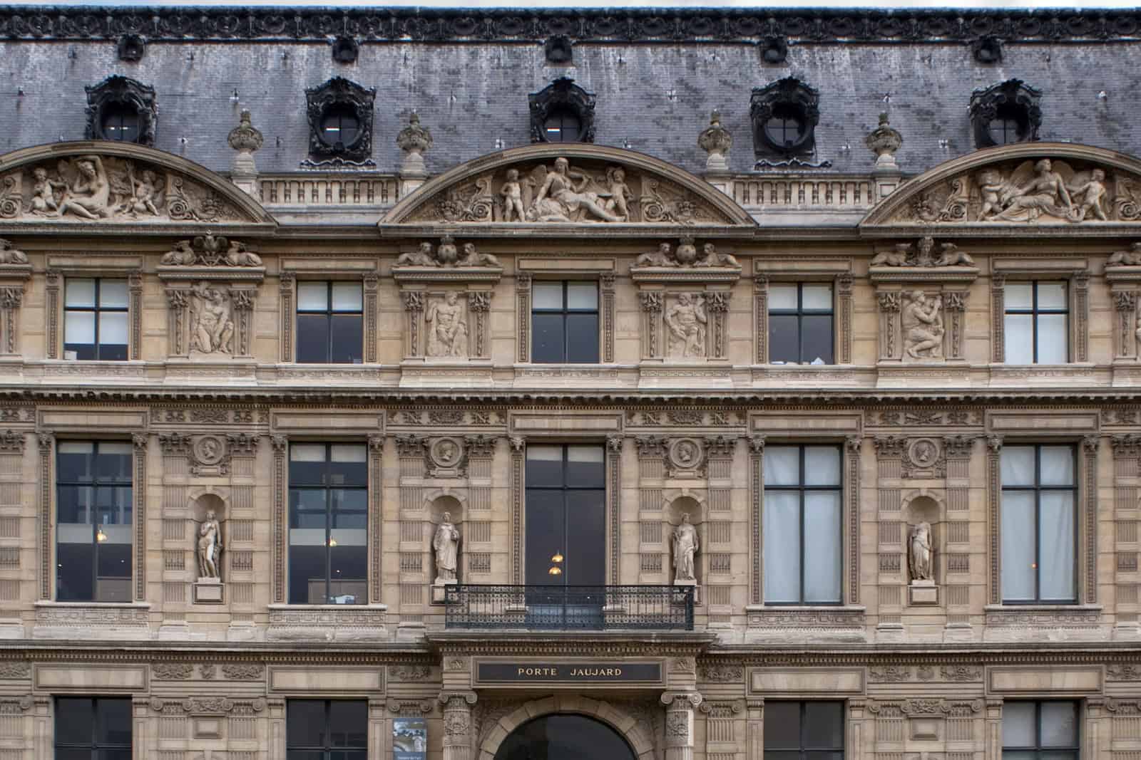 The stone Porte Jaujard entrance to the École du Louvre is set into the Louvre Palace’s Flore Wing.