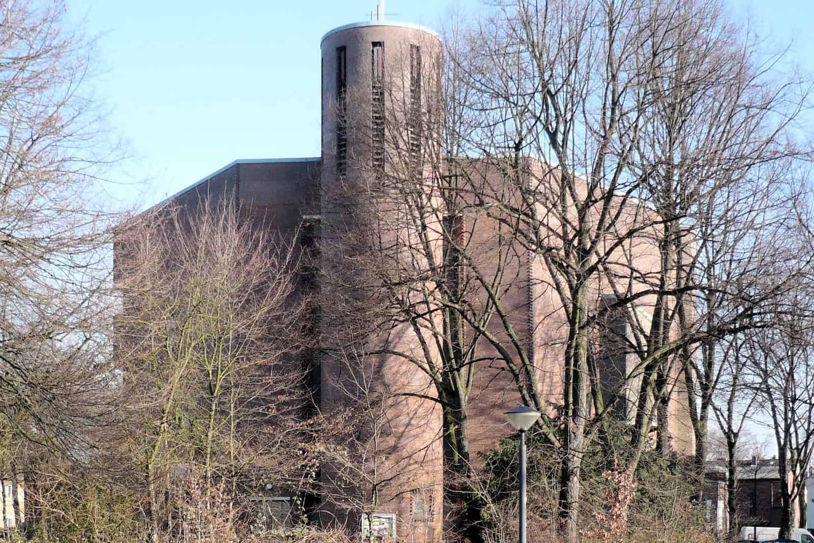 The dark brick exterior and tall angular roofline of St. Marien in Essen-Karnap.