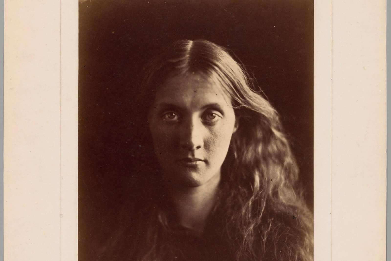 Julia Jackson looks toward the camera in a close albumen portrait made in 1867.