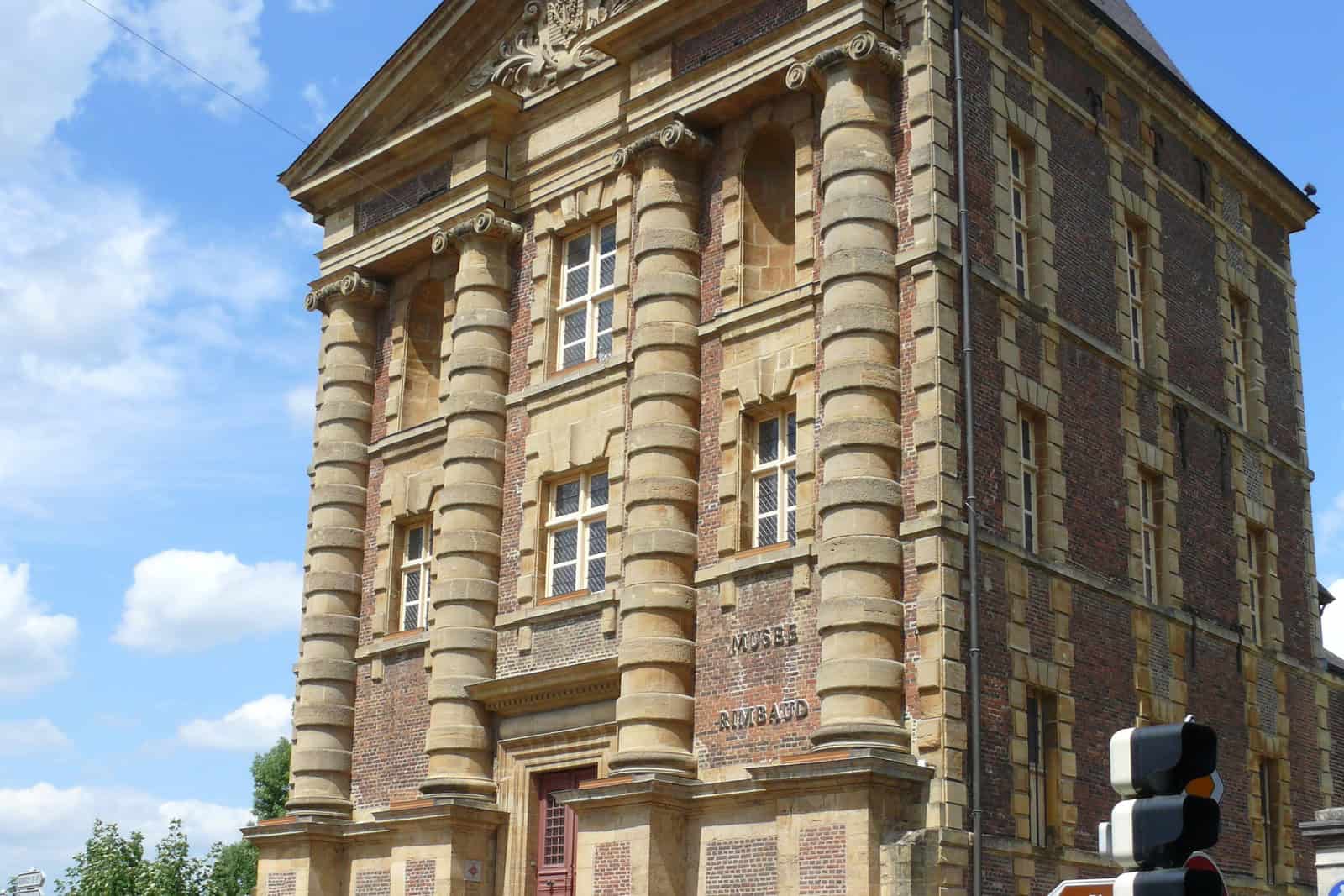 Historic stone façade of the Musée Rimbaud beside the Meuse in Charleville-Mézières.