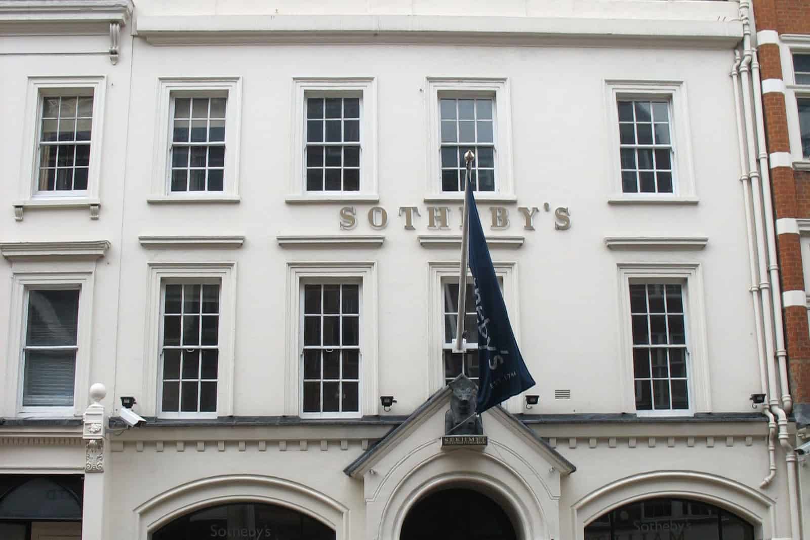 Sotheby’s New Bond Street entrance beneath an ornate clock and architectural sculpture.