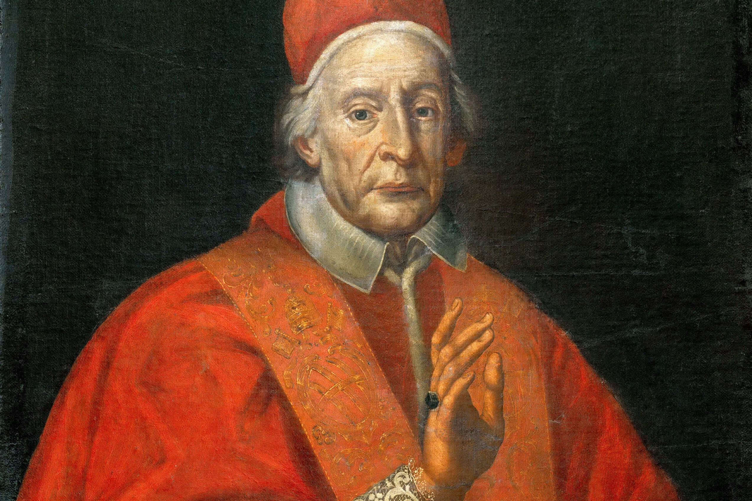 Pope Clement XII sits in red papal robes, facing the viewer with one hand resting on a chair.
