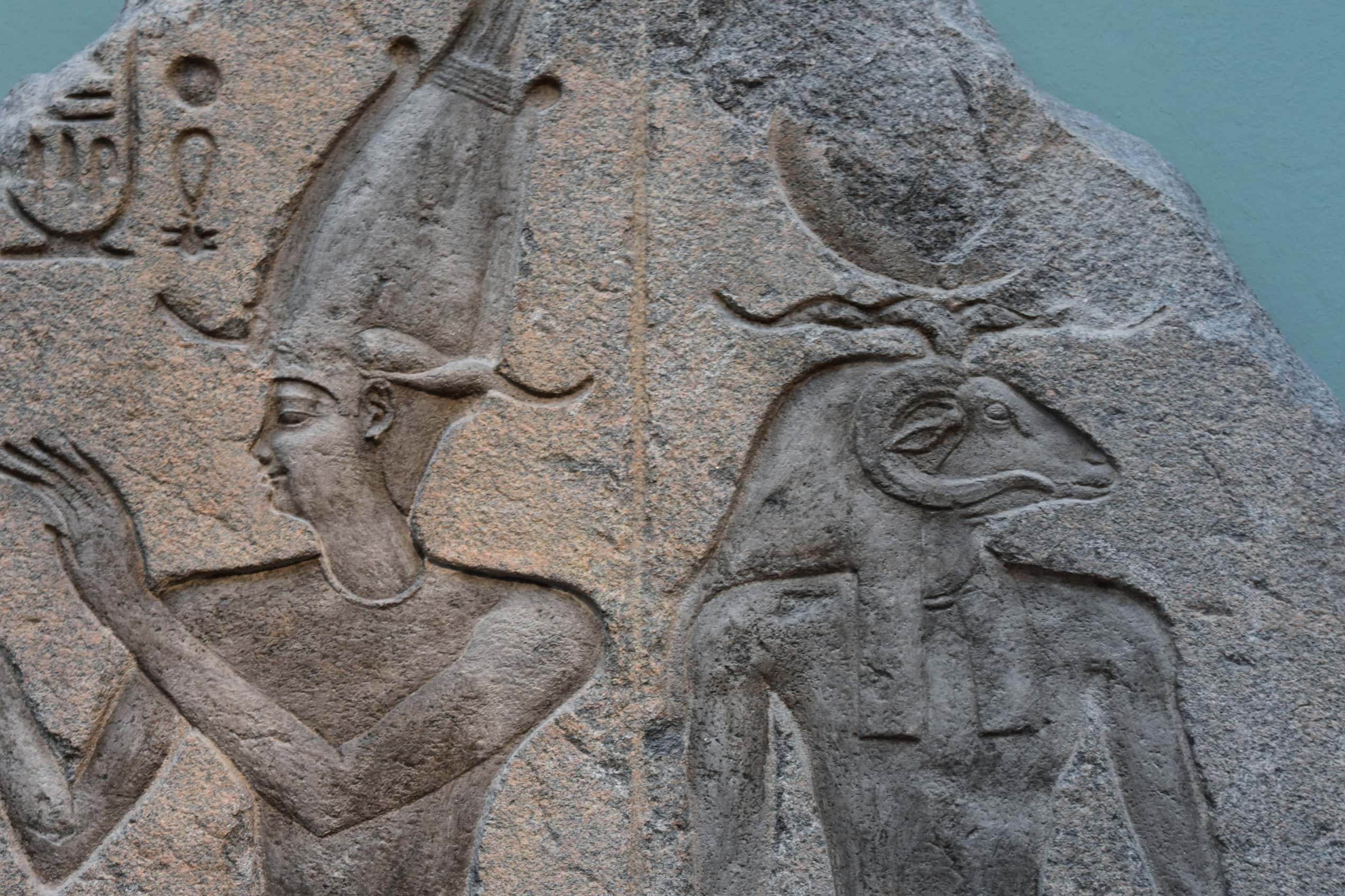 A Ptolemaic relief from Behbeit El-Hagar shows a king facing a ram-headed god.