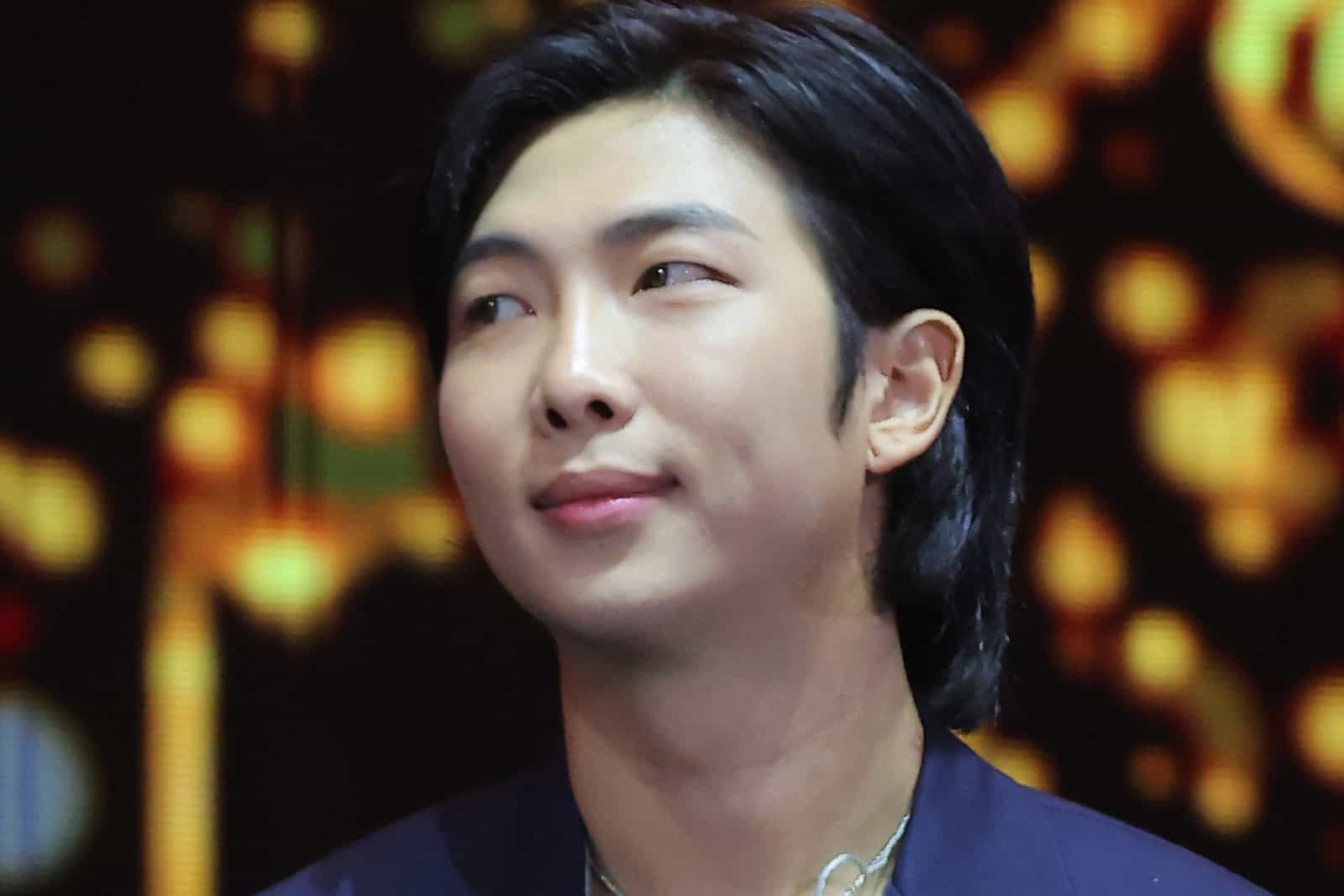 RM looks toward the camera while attending the 2022 Fact Music Awards.