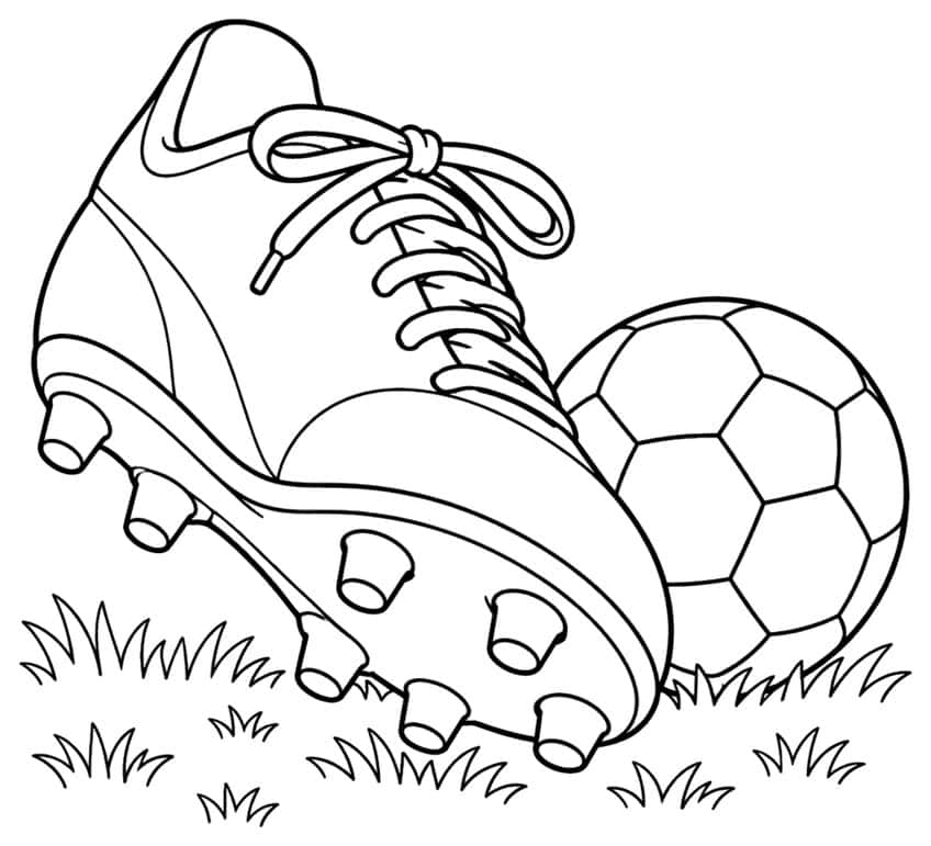 Soccer cleat with studded sole and laces next to a soccer ball on grass tufts