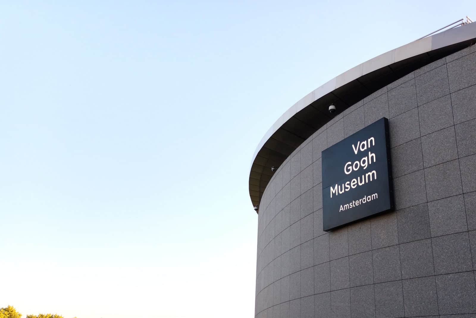 Brick façade of the Van Gogh Museum in Amsterdam with its name displayed above the entrance.